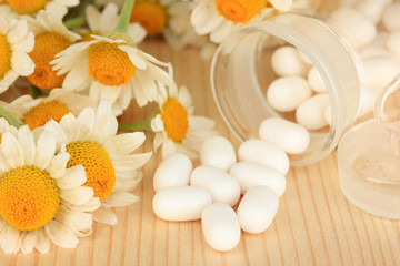 Fototapeta na wymiar Medicine chamomile flowers on wooden table