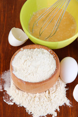 Ingredients for dough on wooden table close-up
