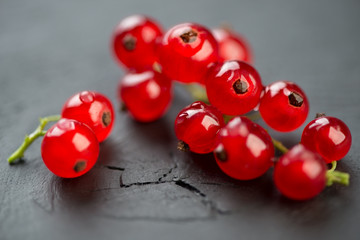 Macro shot of red currant over dark wooden background