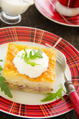 Potato gratin with cheese and meat.