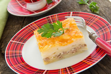 Potato gratin with cheese and meat.