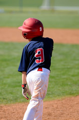 Youth ballplayer in helmet on base
