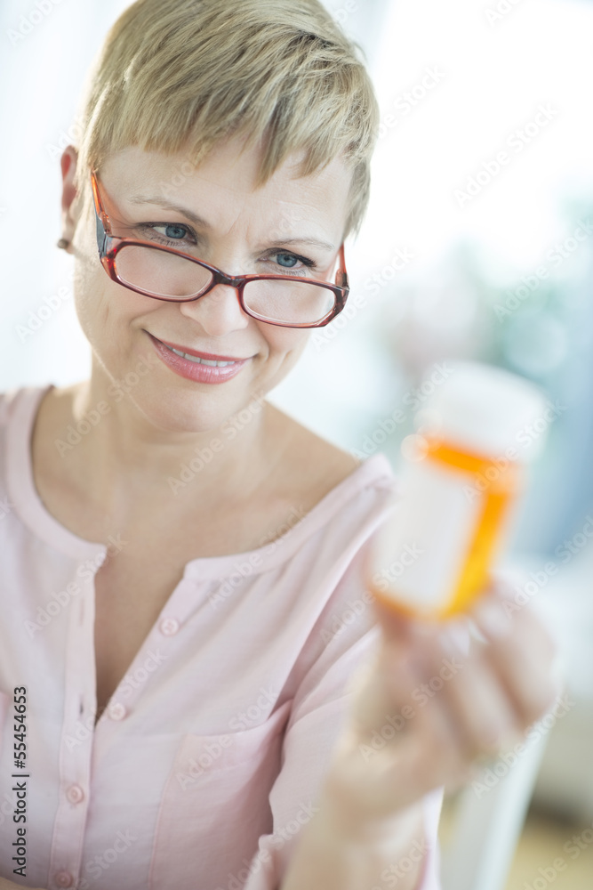 Wall mural Woman Looking At Pill Bottle