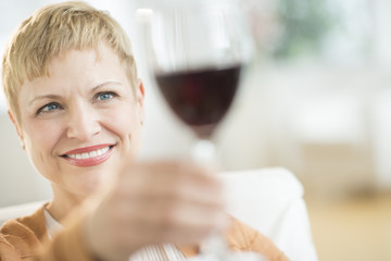 Woman Holding Up Red Wineglass