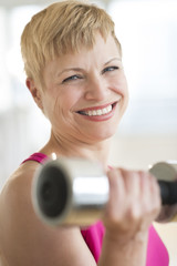 Happy Mature Woman Lifting Weights