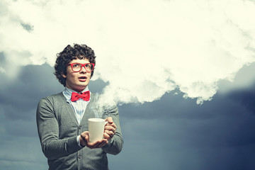 Young man with smoke coming out of cup