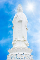 beautiful white marble guan yin with blue sky backgroung