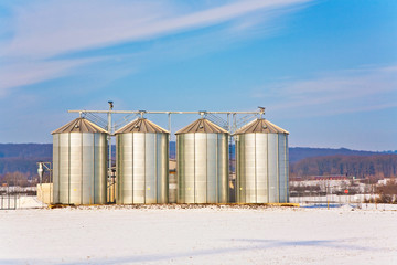 beautiful landscape with silo and snow white acre with blue sky