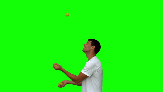 Man dribbling with balls on green screen