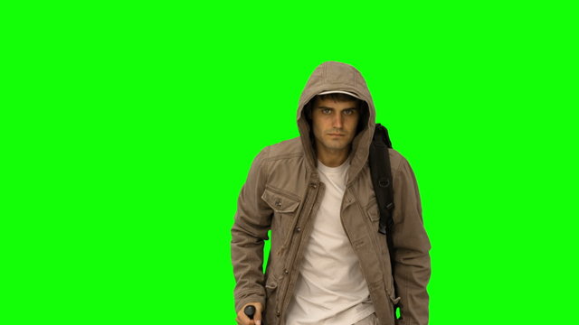 handsome man with a coat trekking on green screen