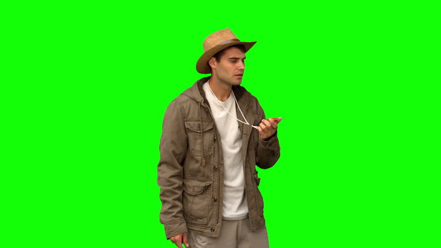 Lost man using a compass on green screen