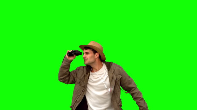 Man jumping and using binoculars on green screen
