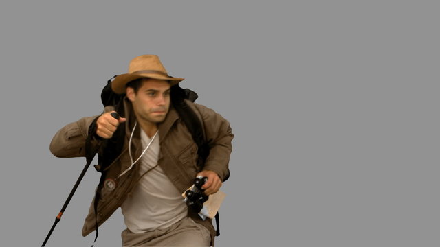 Man orienteering while holding a hiking stick on grey screen