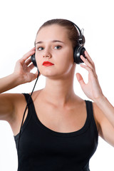 Naklejka premium brunette womanl with headphones on white background