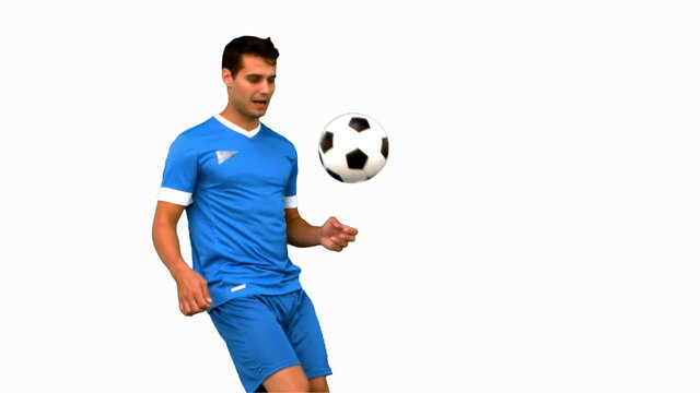 Attractive man juggling a football on white screen