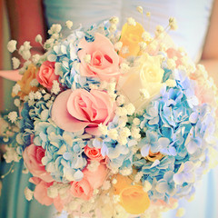 Bride or bridemaid with bouquet, closeup with retro filter effec