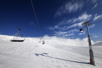 Gondola and chair lift at nice sunny day