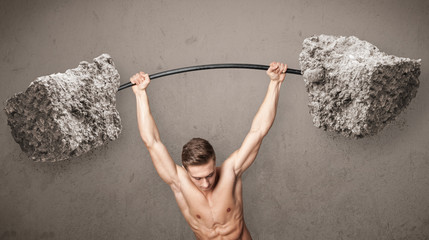 muscular man lifting large rock stone weights