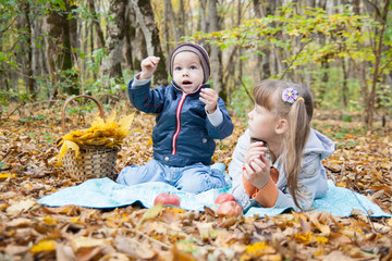 Boy and girl sitting on log