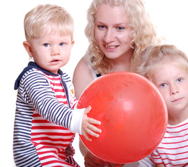 Fototapeta na wymiar happy mother with two young kids with a ball