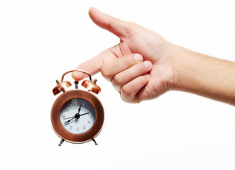 Hand with alarm clock.