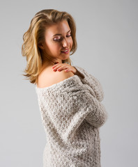 Fashion portrait of young girl on grey background