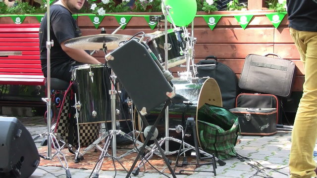 Drummer performing during a live concert outdoors