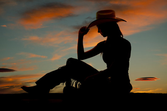 silhouette western woman side sit tip hat
