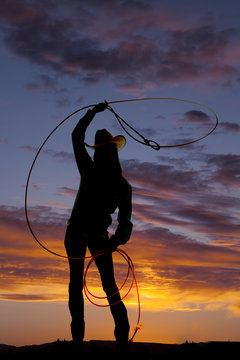 silhouette western woman twirl rope