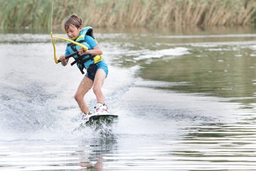 young boy wakeboarding