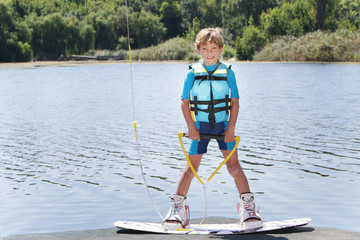 young boy wakeboarding