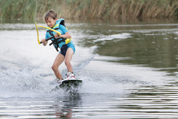 young child boy wake boarding