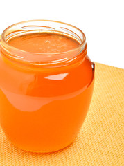 Glass jar with golden fresh honey