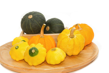 Yellow Patty Pan And Pumpkin on the wooden tray