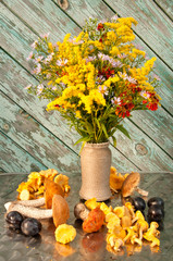still life of yellow flowers bouquet with mushrooms