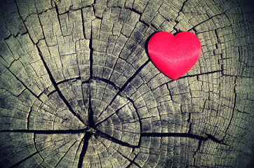 Vintage photo of red heart on a wooden background