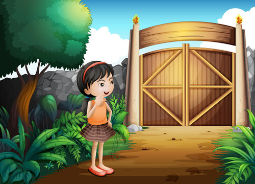 A gated yard with a young girl