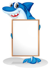 Fototapeta premium A smiling shark holding an empty whiteboard