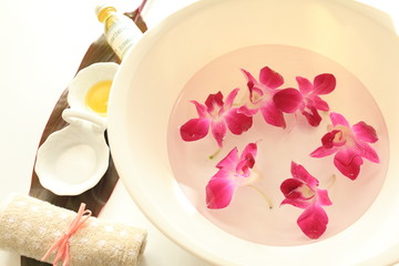 orchid and water with message oil for spa image