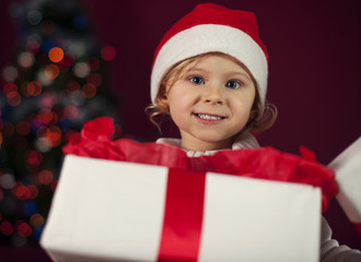 Santa little girl opening christmas present