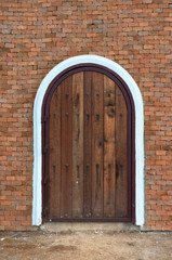 arch wooden door with brick building