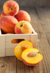 Naklejka na ściany i meble Fresh peaches in wooden box