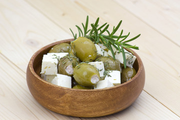 feta cheese and olives with herbs in olive oil
