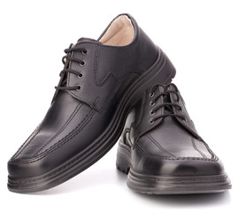 Black glossy man’s shoes with shoelaces