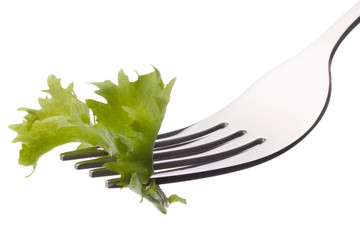 Fresh lettuce salad  on fork isolated on white background cutout