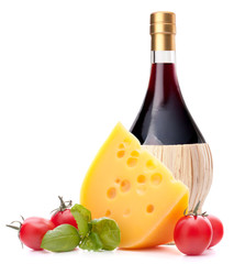 Red wine bottle, cheese and tomato still life