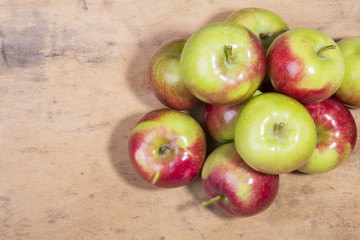 pile of apples on a wooden background