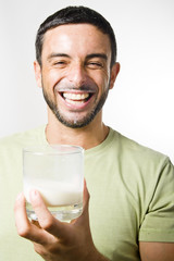 Young Handsome Man with Beard drinking Milk