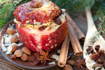baked apple with christmas spices on wooden background
