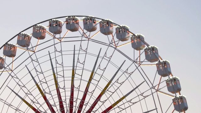 Rotating Ferris wheel noria at sunset with neon ( 2 cuts )